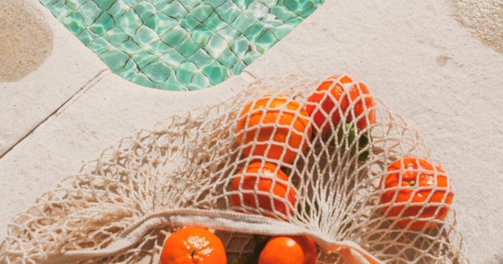 oranges next to a pool, representing life after healing from anorexia and bloating